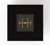  A gold-colored crossfire gas burner inside a warming trends fire pit that is in a black square frame finish. 103816BLK