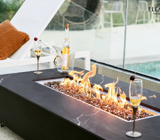 black rectangular fire pit table with two wine glass and wine cooler