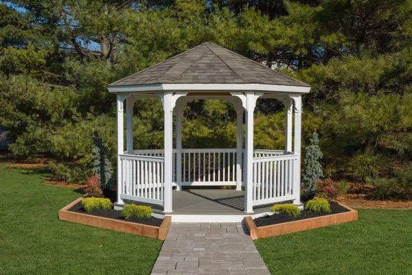 A white vinyl octagonal gazebo with a gently sloping roof. The gazebo has open sides and a decorative roofline.