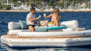 Two people on a YachtBeach inflatable yacht platform in the water.