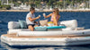 Two people on a YachtBeach inflatable yacht platform in the water.