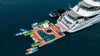 Yacht with a floating pool and water toys on a clear day