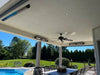 Outdoor patio area with patio heater, pool, table, chairs, and ceiling fan under a covered area.