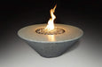 white round fire pit table with round fire pit in the middle with fire glass burning and blowing yellow and orange flames on a black background