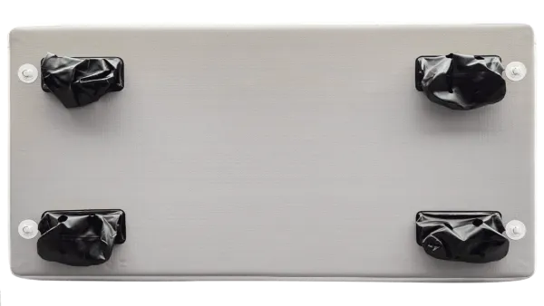 Metallic panel with four black knobs on a white background