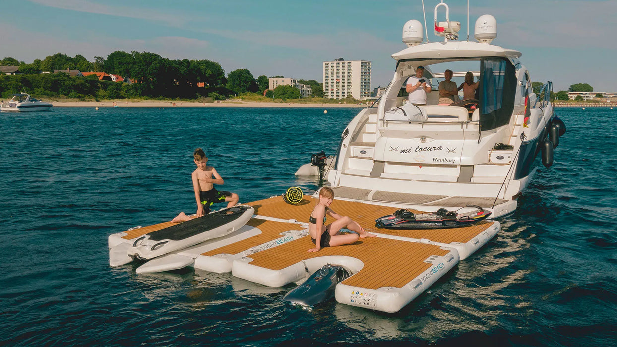 People on a boat with an inflatable platform in the water
