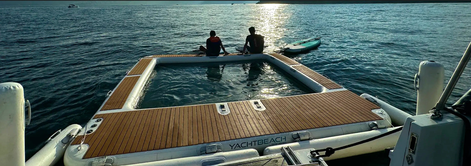Two people on a floating dock by the water