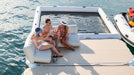 People relaxing on an inflatable sofa on a boat in the water