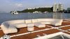 Inflatable sectional sofa on a dock by a body of water with buildings in the background