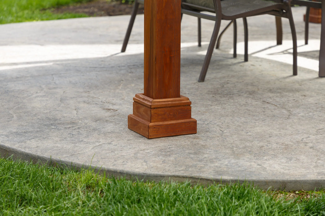 A close-up of a wooden pavilion frame with notched beams and pre-drilled holes for assembly.